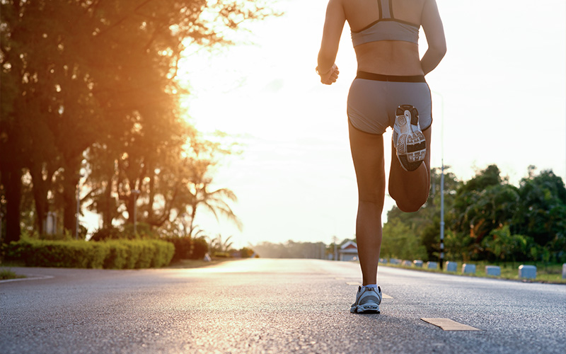 Woman running, requiring sports podiatry care.